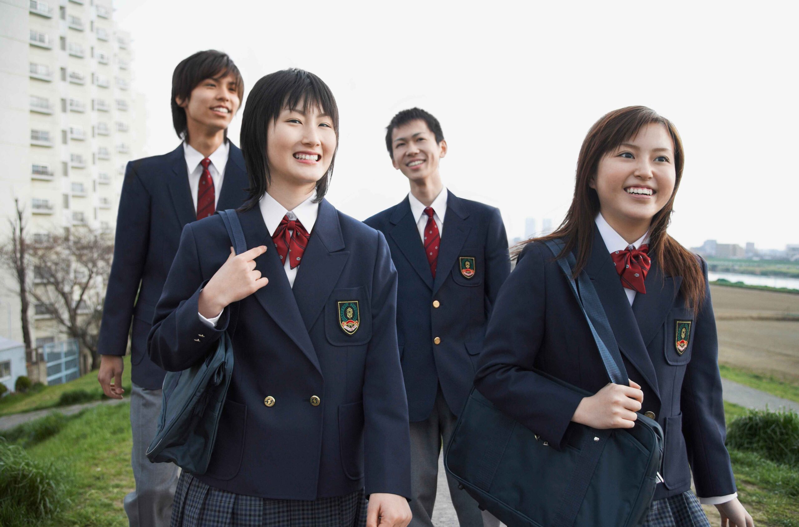 four-smiling-school-students-walking-on-a-path-2429701